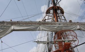 ❸帆桁にわたり、帆をしばってあるロープをとき終って降りる。